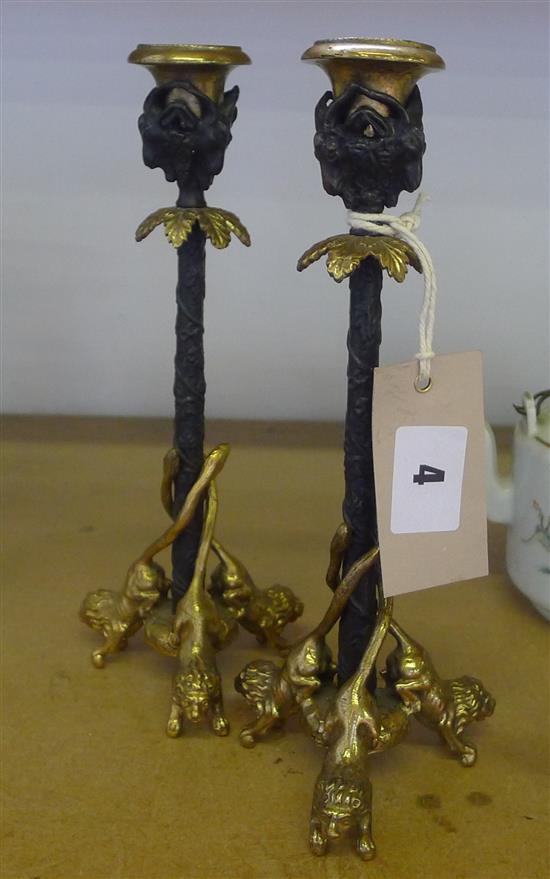 Pair of French style cast brass and bronze candlesticks on tripartite lion supports